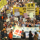 More than 1,000 people march in downtown Hong Kong on Sunday, Jan. 23, 2005, to demand full democracy and social justice in the Chinese territory. The protesters chanted, "Direct elections in 2007 and 2008," the years in which Hong Kong is due a to get new leader and legislature.